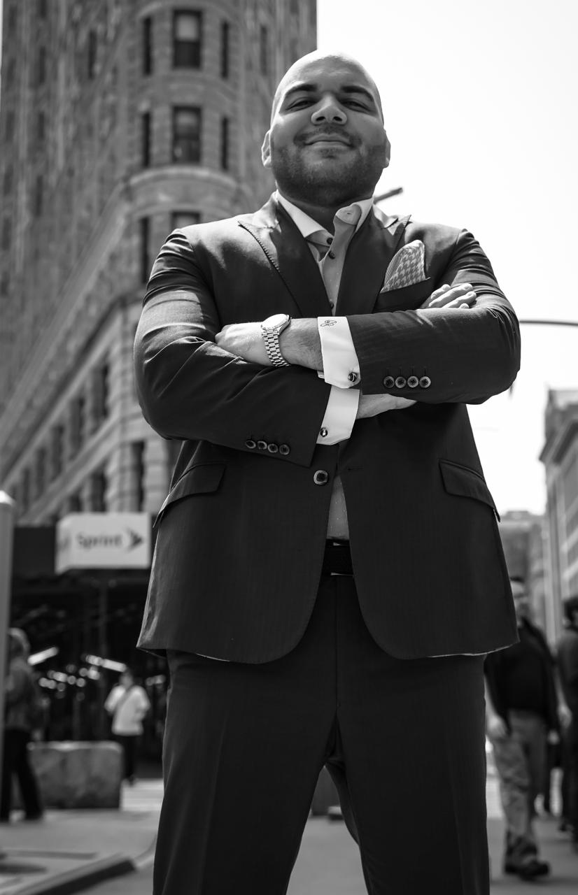 Carlos Angelucci outside the Flatiron Building, arms crossed
